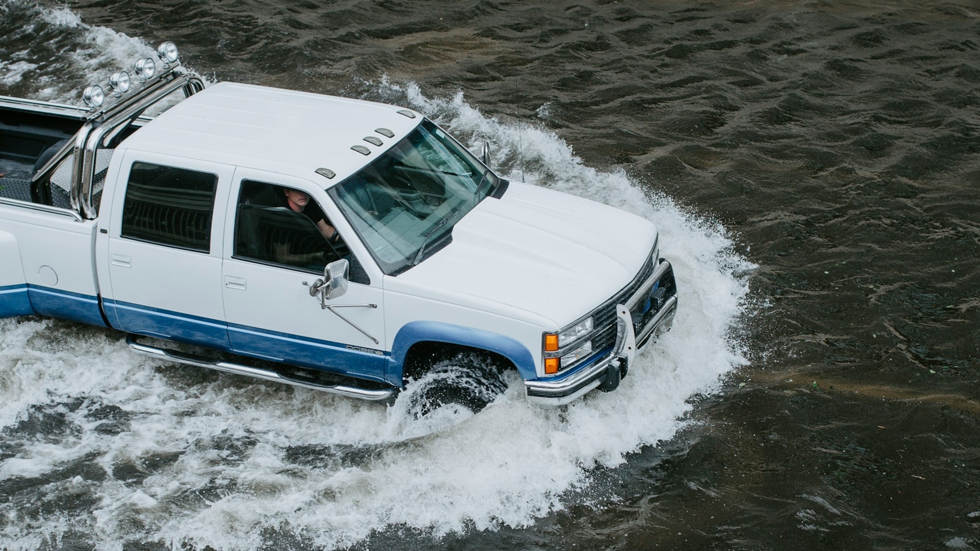 Couple sitting together on couch looking at laptop
